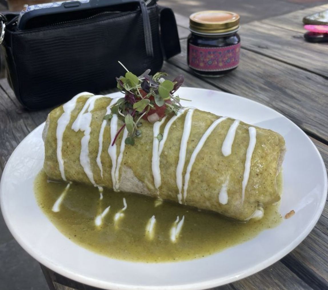 Breakfast burrito smothered in salsa verde and crema at Picazo Café