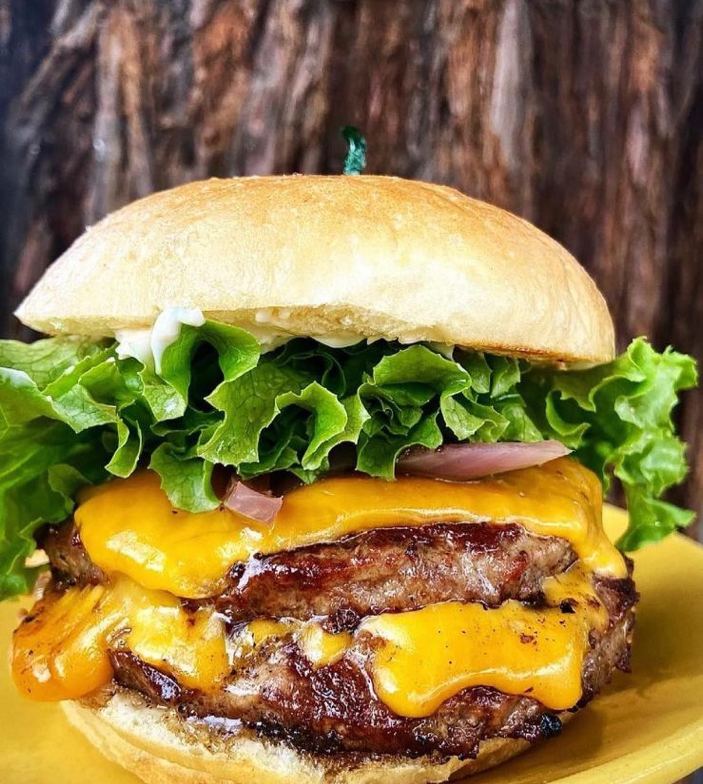 The Picazo Burger — double patty with melted cheddar, grilled onions, lettuce, tomato, pickles and Picazo Sauce