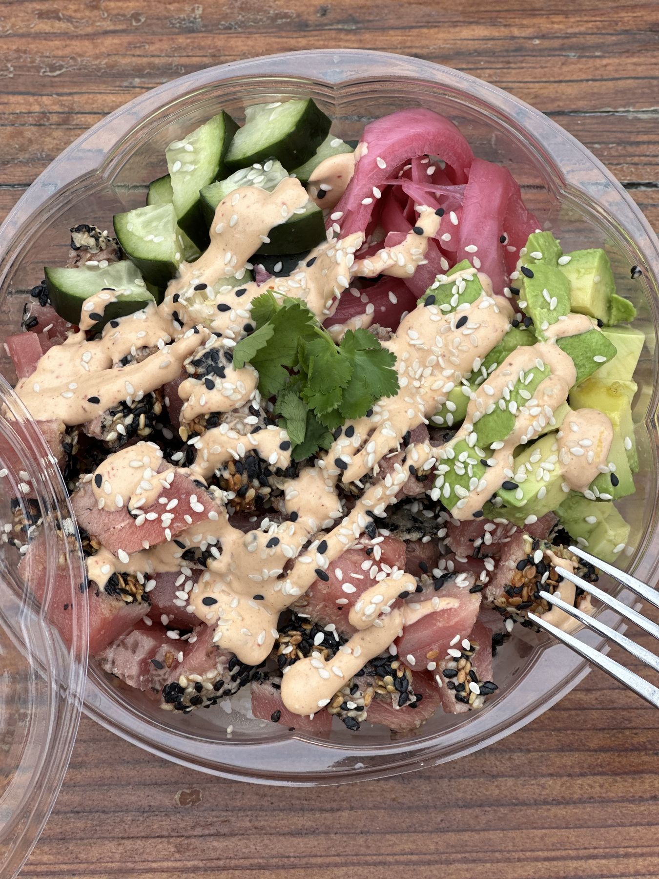A colorful Picazo Rice Bowl with cucumber, pickled onion and bold sauce drizzle