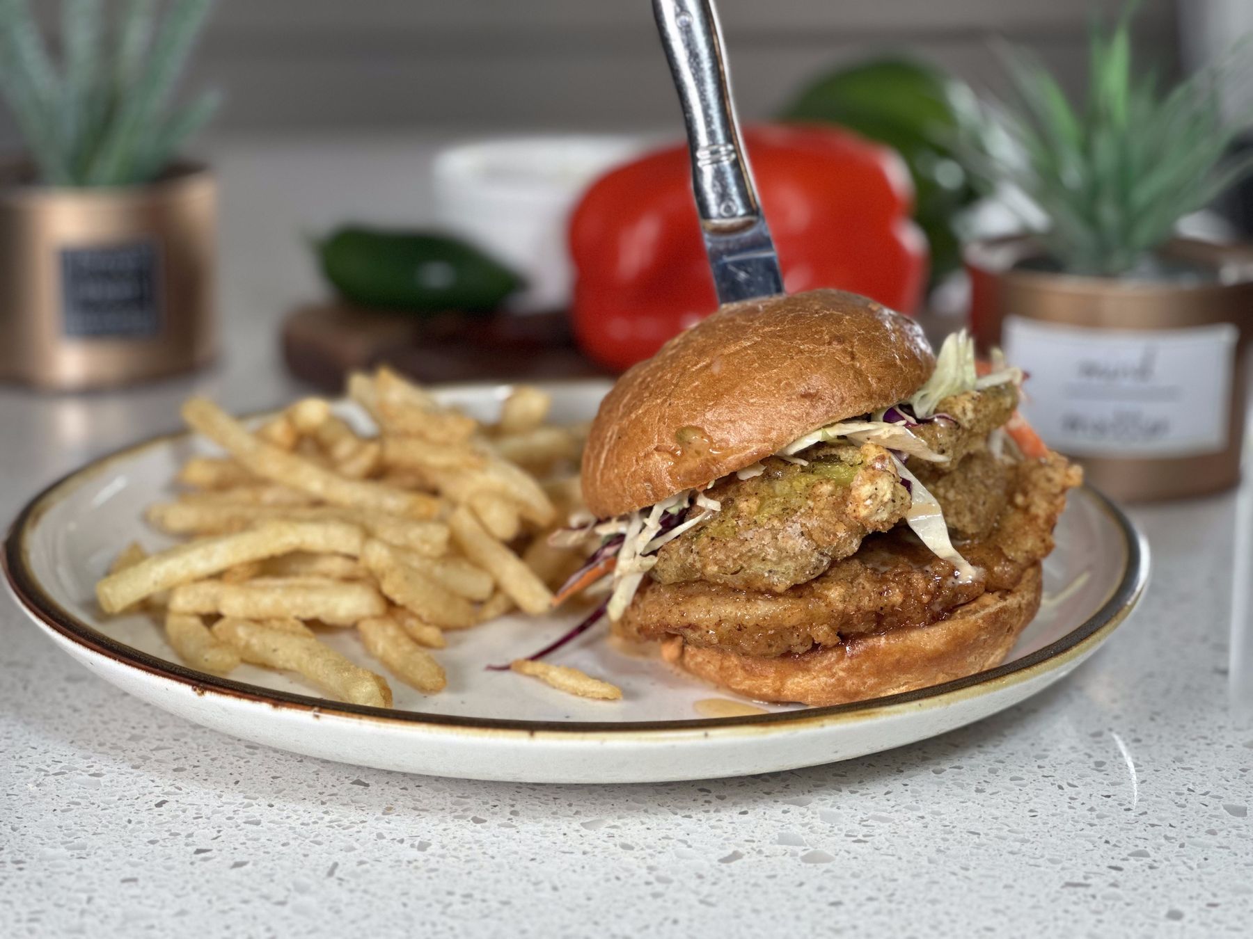 Señor Crispy fried chicken sandwich with slaw, pickles and sweet chili bacon aioli, served with fries