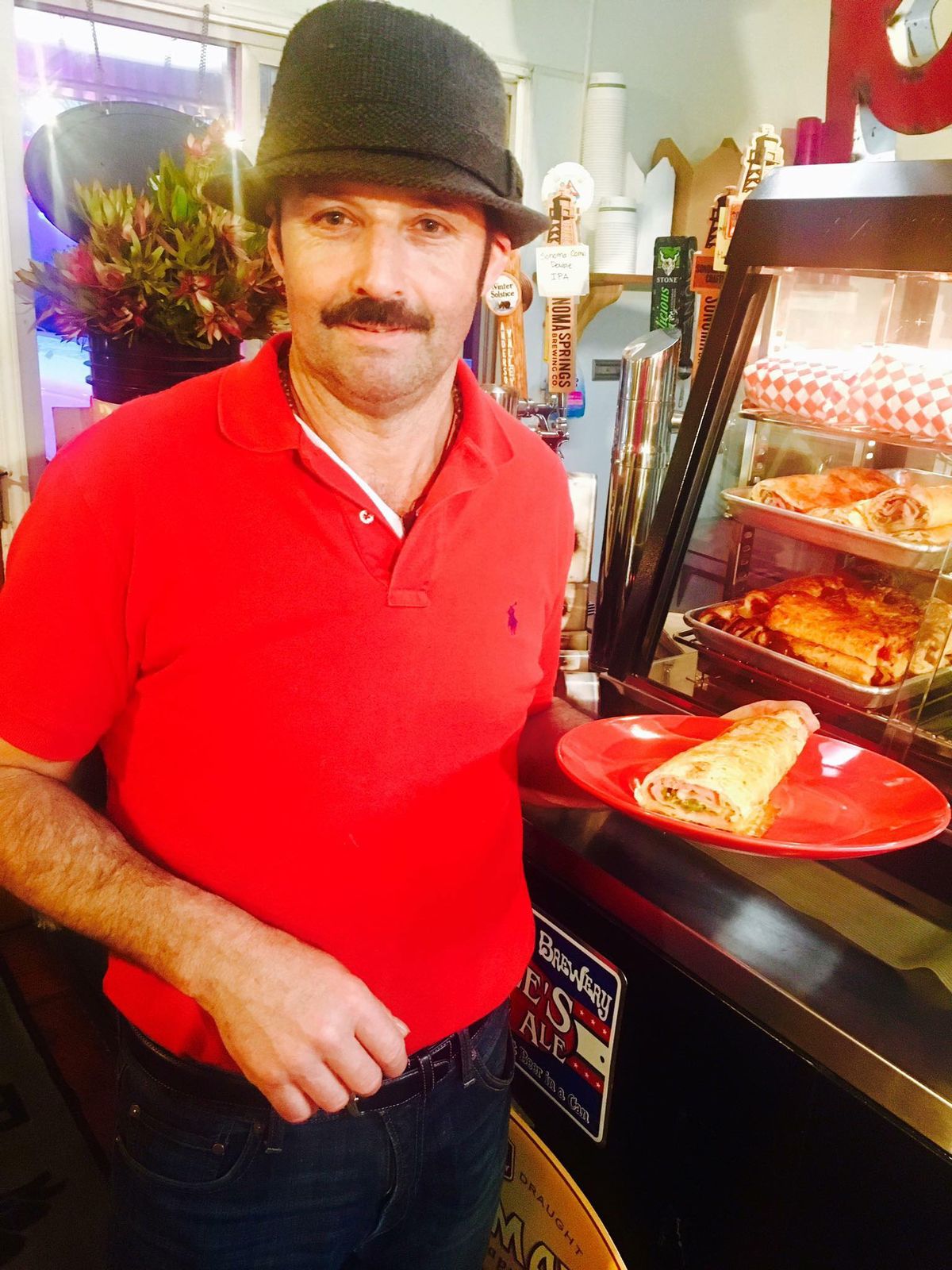 Picazo team member with a fresh house-baked pastry at the counter