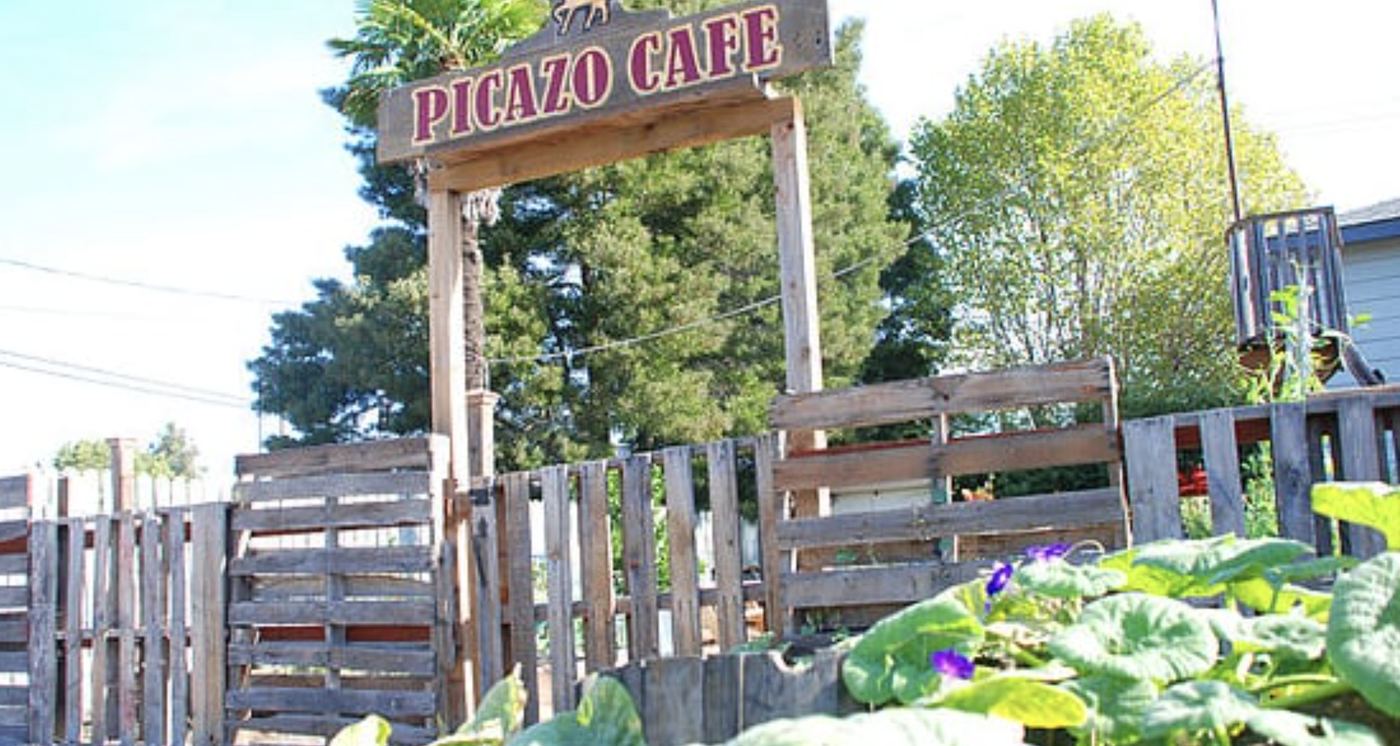 The handmade Picazo Café sign over the garden patio